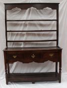 A 19th century oak South Wales dresser, the open rack with an arched frieze and three shelves, the