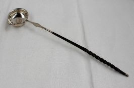 A white metal toddy ladle inset to the bowl with a George II coin dated 1758, on a turned horn
