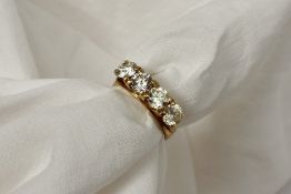 A four stone diamond ring set with round old cut diamonds each approximately 0.4 of a carat to a