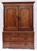 A 19th century oak linen press, the moulded cornice above a pair of panelled doors, the base with