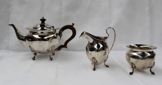 A George V silver three piece teaset of circular panelled form, with a gadrooned edge, Birmingham,
