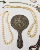 An ivory bead necklace together with a hand mirror, assorted costume jewellery including faux