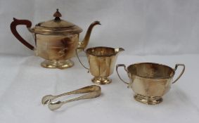 A George VI silver three piece tea set of panelled circular form, Birmingham, 1937, Adie Brothers,