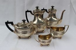 An Edward VII silver five piece tea and coffee set, with a panelled body and ribbed decoration,