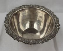 An Edward VII silver bowl of circular form, the edge decorated with flower heads and leaves on a