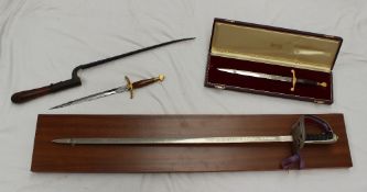 A Wilkinson sword presentation dagger contained within a case together with another, the blade
