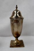 An Elizabeth II silver sugar caster, the pierced domed cover with a turned finial above a tapering