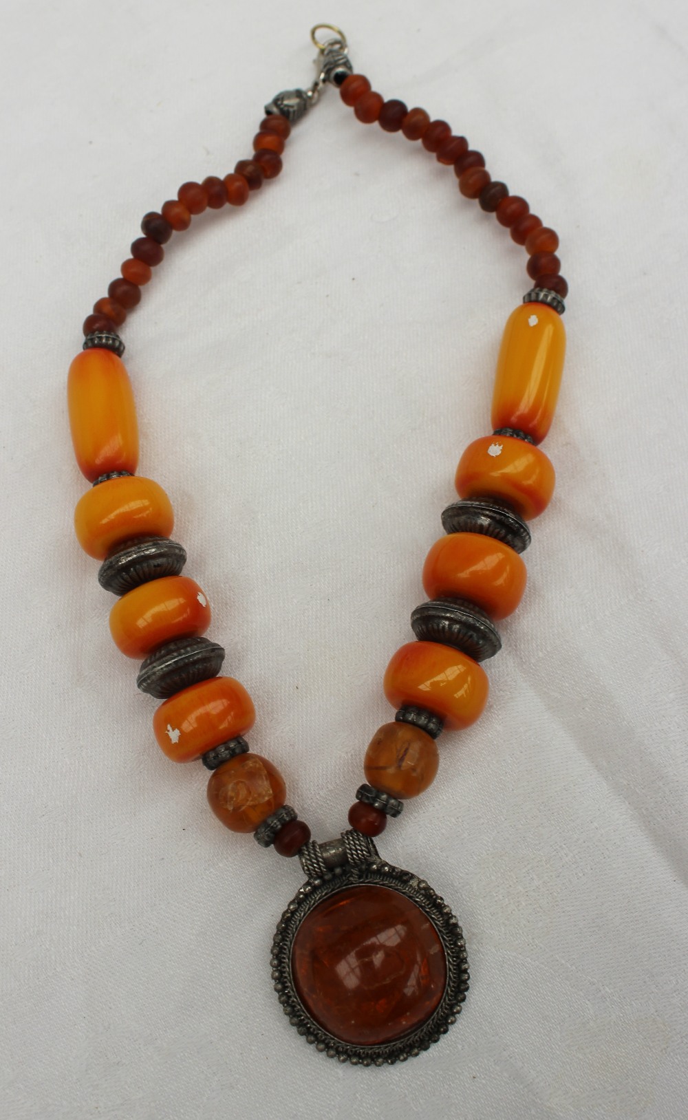 A faux amber and white metal necklace