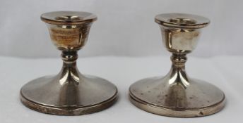 A pair of Elizabeth II silver desk candlesticks with a fixed sconce on a spreading foot, Birmingham,