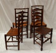 A matched set of four ladder back dining chairs with solid seats on turned legs united by