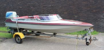 A Concorde fibre glass speed boat in red and grey with a Suzuki DT65 outboard motor with trailer