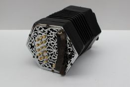 A C Jeffries concertina with nickel plated pierced ends, having three rows of bone buttons (34 in