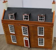 A dolls house of large size with a hinged roof and a pair of hinged doors, together with dolls house