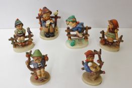 Six Goebel figures by M.J Hummel including Apple Tree Girl, Just Resting, Retreat to Safety, She