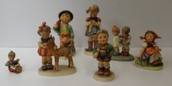 Seven Goebel figures by Hummel including Trumpet boy, A stitch in time, Token of Love, In the Meadow