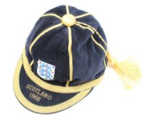 A blue velvet cap with gold piping applied with the three Lions badge and embroidered "Scotland
