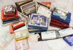 Stock books containing world stamps together with first day covers, collectors packs of stamps,