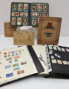 A stamp album containing world stamps, together with a file containing stamps and assorted cigarette