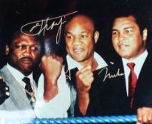 A colour photograph of Muhammad Ali, Joe Frasier and George Foreman, signed by in gold pen, 20 x