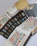 Two stamp albums and loose world stamps together with a Wills cigarette album etc