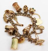 A 9ct yellow gold charm bracelet set with numerous charms including a 22ct yellow gold wedding band,