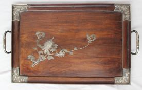 An oriental hardwood twin handled tray, the corners decorated with white metal chrysanthemums, the