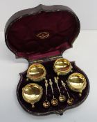 A set of four Victorian silver gilt open table salts, of cauldron shape, decorated with leaves on