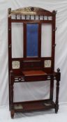 An Edwardian mahogany hall stand, the carved cresting rail above a turned spindle frieze,