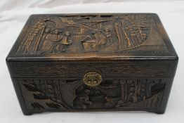 A Chinese hardwood hinged box and cover carved with figures, trees and pagodas, 35cm wide x 21cm