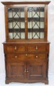 A 19th century oak bookcase, the mounted cornice above a pair of glazed doors with glazing bars, the