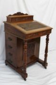 A Victorian walnut Davenport, the raised superstructure with a stationery compartment, above a