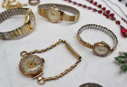 A 9ct yellow gold lady`s wristwatch together with other ladies` wristwatches, costume jewellery