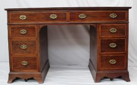 An Edwardian mahogany desk, the rectangular cross banded top above two drawers and two banks of