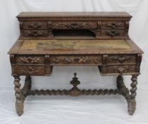 A 19th century Low Countries oak desk, the raised superstructure with an arrangement of drawers