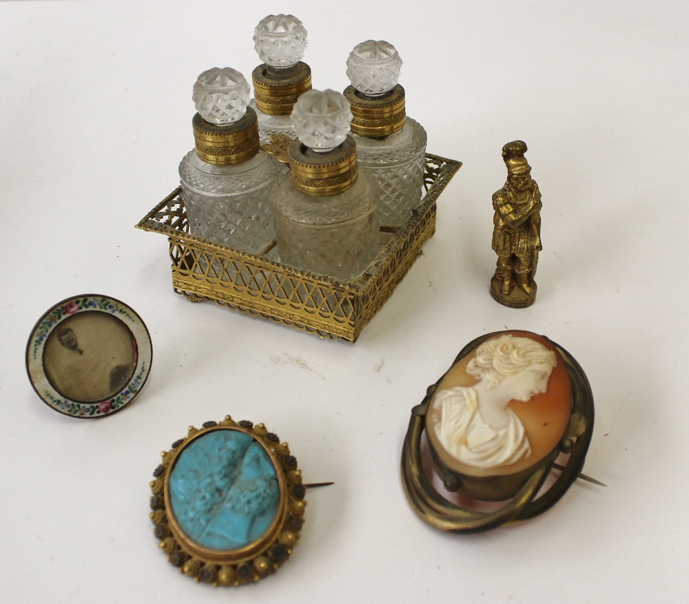 A set of four cut glass and gilt metal mounted scent bottles contained within a gilt metal mounted