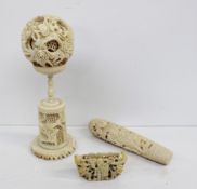 A Chinese carved ivory puzzle ball, decorated with flower heads and leaves on a similarly