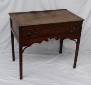 An 18th century oak lowboy, the planked rectangular top above a single cross banded drawer, a shaped
