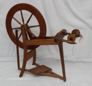 A 20th century treadle operated spinning wheel, 85cm high x 75cm wide