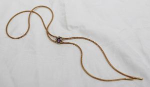 An 18ct carat yellow gold rope necklace with a circular sliding pendant set with an amethyst and