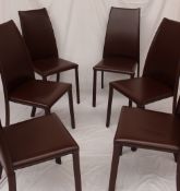 A set of six brown leather Frag dining chairs with swept backs on cylindrical front legs and sabre