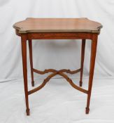 A satinwood occasional table, the shaped top above a shallow apron on four square legs and spade