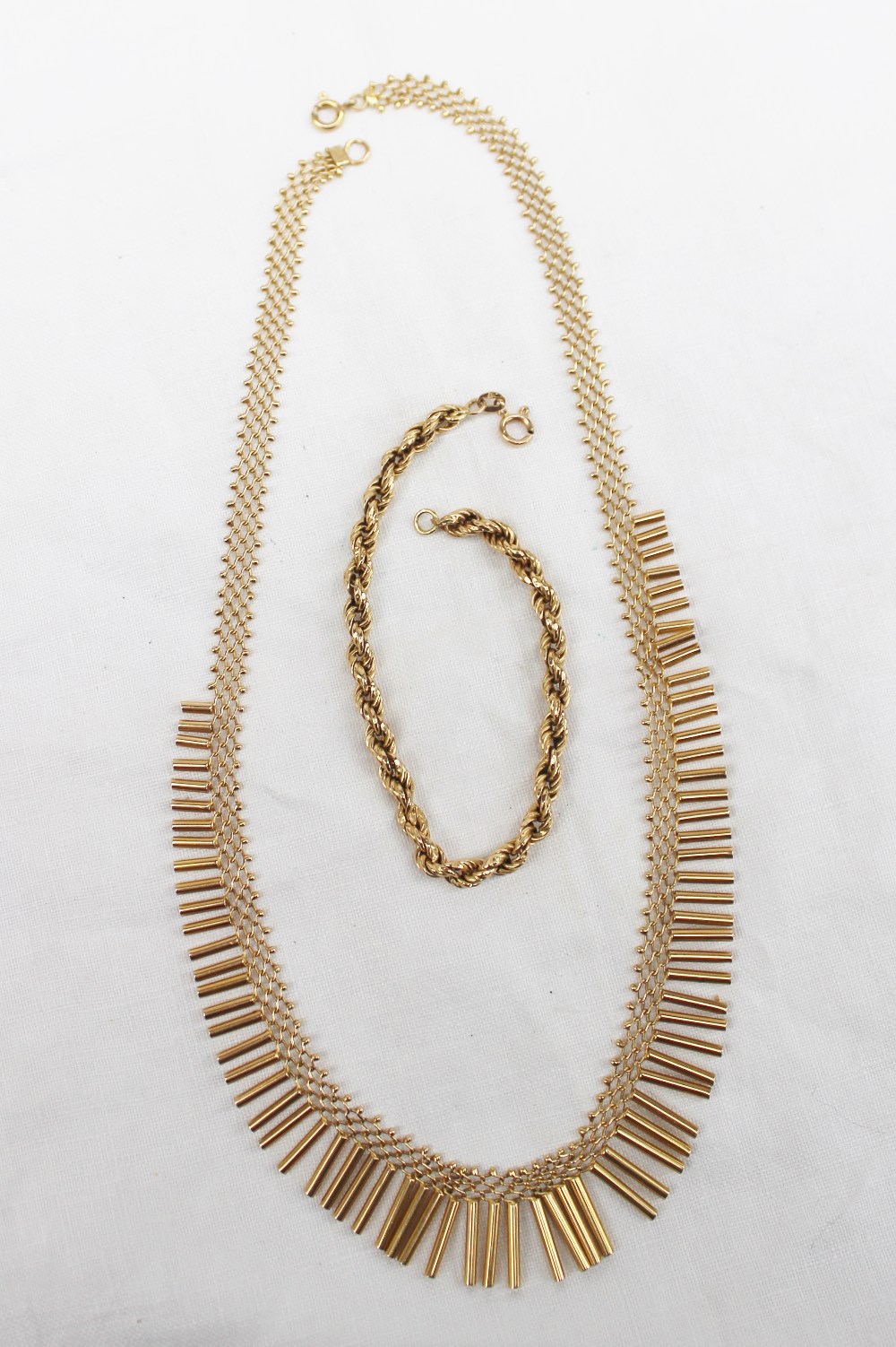 An 18ct yellow gold rope twist  bracelet together with a yellow metal fringe pattern necklace