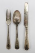 A late Victorian silver three piece Christening set comprising a spoon fork and knife with beaded