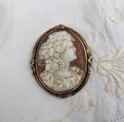 A shell cameo brooch depicting Bacchus in profile to a yellow metal mount, 5 x 4cm