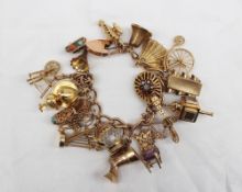 A 9ct yellow gold charm bracelet  set with numerous charms including a gramophone, spinning wheel,