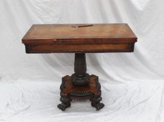 An early 19th century rosewood card table, the rectangular top with a baize interior on a leaf