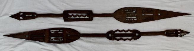 A pair of African hardwood spear shaped paddles with pierced decoration, 164cm long