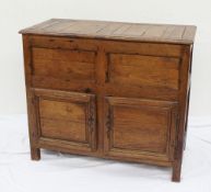 An 18th century continental oak side cabinet, the hinged planked top enclosing a vacant interior