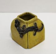 A Chinese vase of square form with applied dragon to a yellow ground, seal mark to the base, 5cm