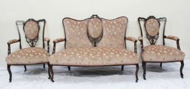 An Edwardian part salon suite comprising a two seater settee and two elbow chairs with pad